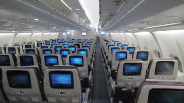 Jet airplane interior view economy class monitors on seats — Stock Video