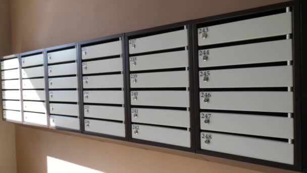 Dlouhá řada poštovních schránek na hnědé stěně — Stock video