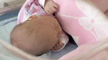 Yeni doğmuş bir bebek Pembe battaniye altında uyuyan bir closeup