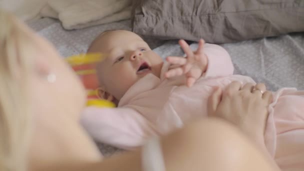 Mum looking at playful baby daughter — Stock Video