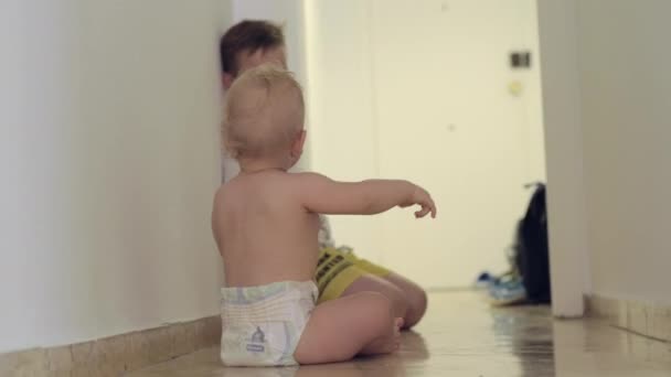 Boy playing with baby sister at home — Stock Video