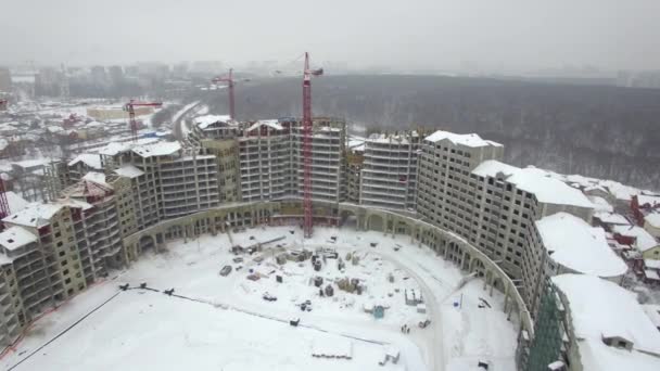 An aerial view of an empty building construction zone in a winter scenery — Stock Video