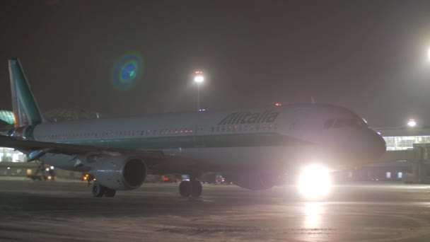 Таксинг самолетов Alitalia в аэропорту Шереметьево ночью, Москва — стоковое видео