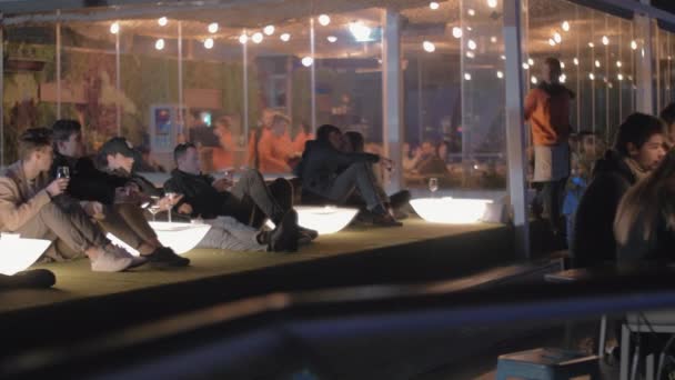 People relaxing in rooftop restaurant Azotea del Circulo at night. Madrid, Spain — Stock Video