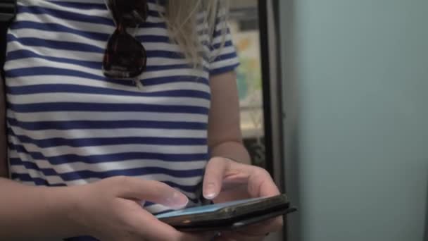 Женщина смотрит на карту на мобильном телефоне во время поездки на метро — стоковое видео