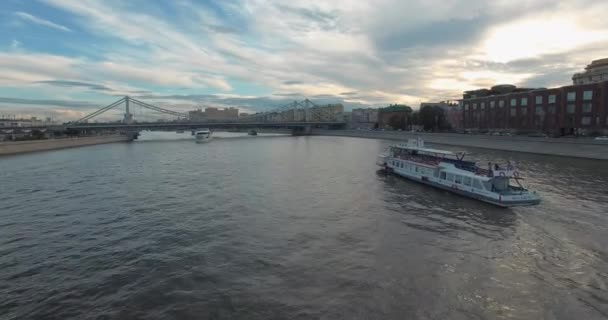 An aerial view of white boats sailing on the river surrounded by the urbanscape — Stock Video