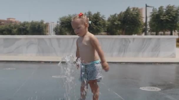 작은 아이는 도시 거리에서 물 재미를 가지고 — 비디오