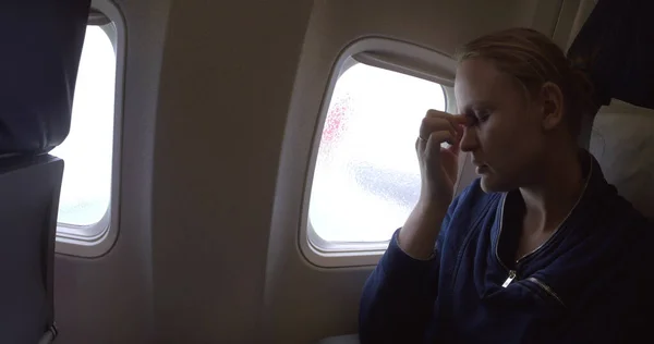 Woman in the plane feeling sick — Stock Photo, Image