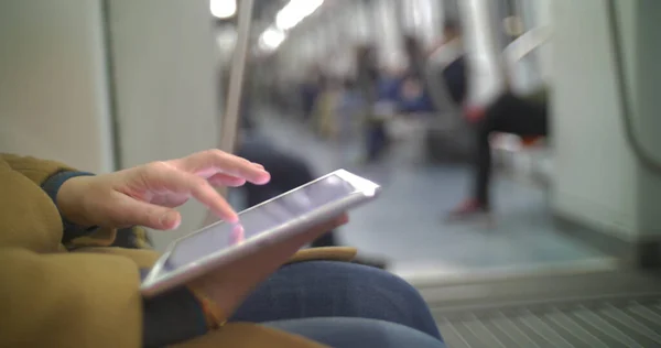 Woman in subway train using tablet PC — Stock Photo, Image