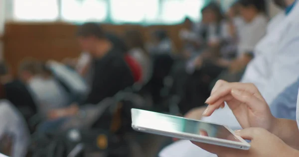 Woman doctor using touch pad on medical conference — Stock Photo, Image