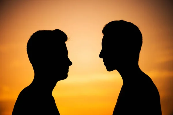 silhouettes of two young friends of the guys