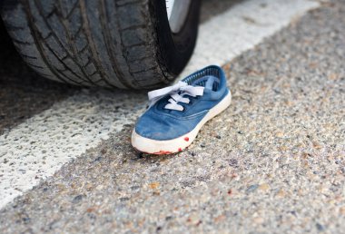 shoes in the blood under the car wheels. clipart
