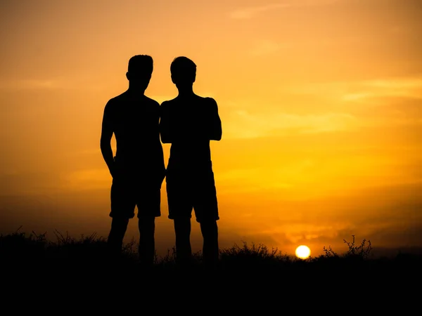 silhouettes of two young friends of the guys