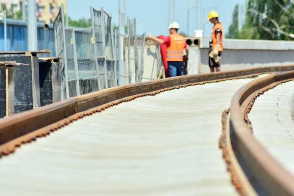 Railway Workers repairing railway on hot summer day