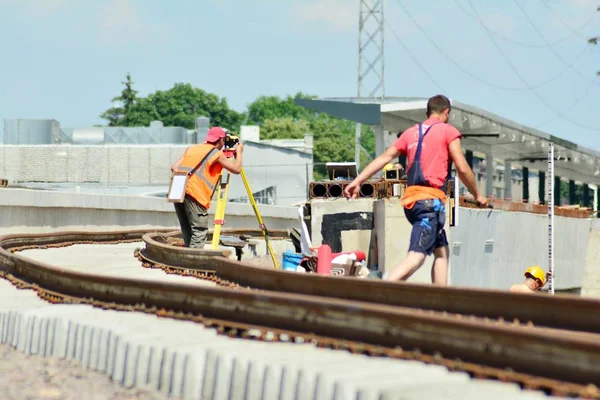 Railway Workers repairing railway on hot summer day