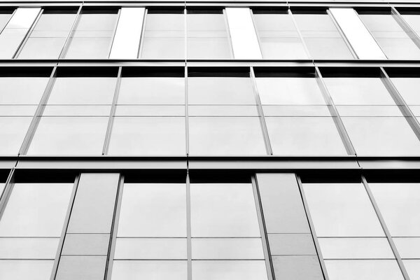 Modern office building wall made of steel and glass. Black and white.
