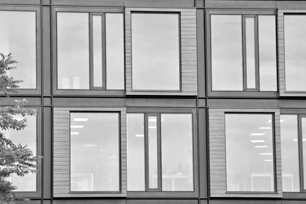 Modern office building wall made of steel and glass. Black and white.