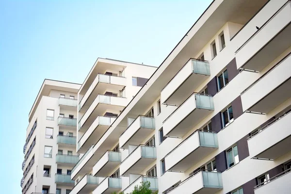 Mavi gökyüzü olan güneşli bir günde modern apartman binaları. Modern bir apartmanın cephesi