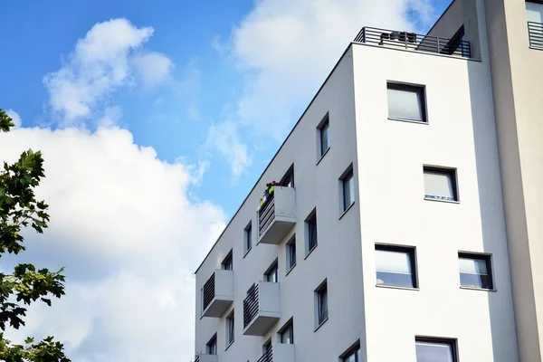 Mavi gökyüzü olan güneşli bir günde modern apartman binaları. Modern bir apartmanın cephesi