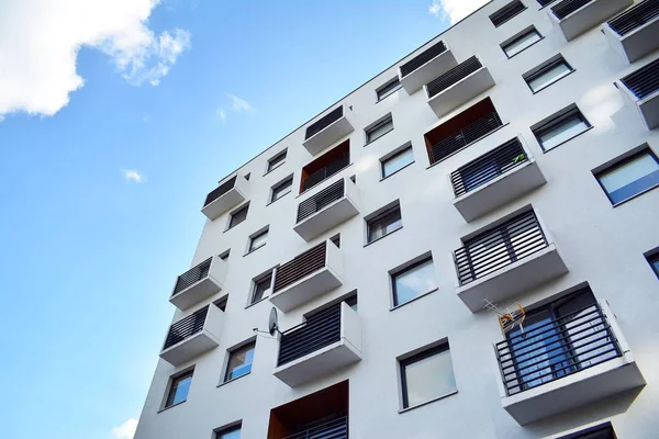 Mavi gökyüzü olan güneşli bir günde modern apartman binaları. Modern bir apartmanın cephesi