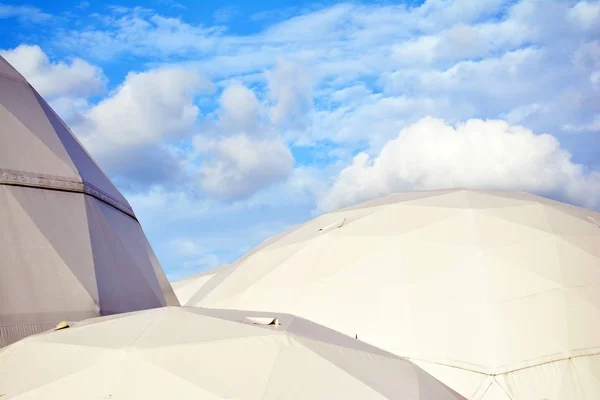 Geodesic dome on a background of blue sky