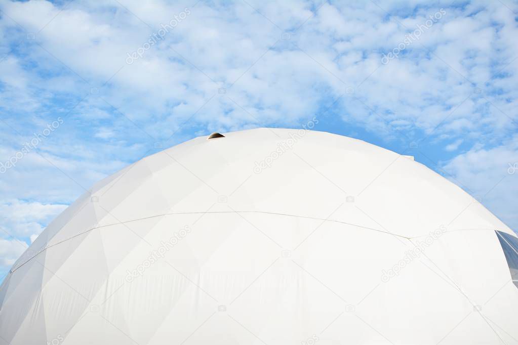 Geodesic dome on a background of blue sky