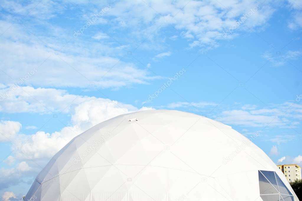 Geodesic dome on a background of blue sky