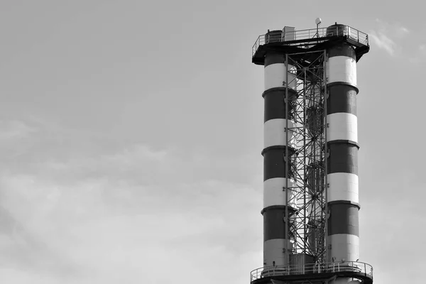 Modern industrial building with a high chimney. Black and white
