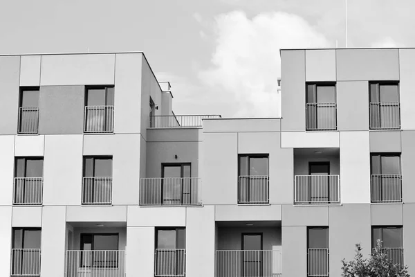 Modern apartment building exterior. Black and white.