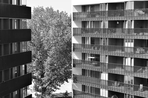 Modern apartment building exterior. Black and white.