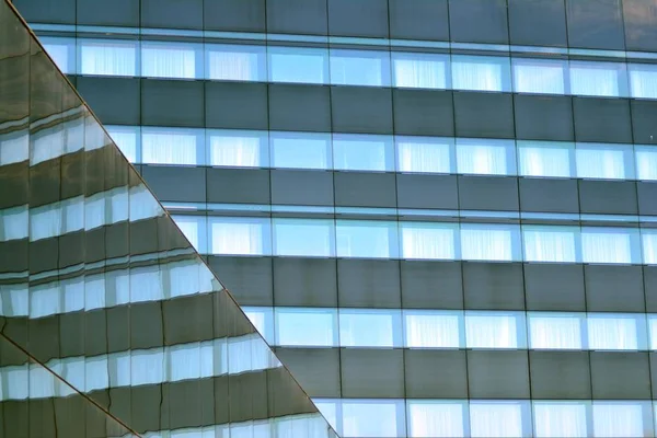 Sky and clouds reflecting on a building with mirrored glass