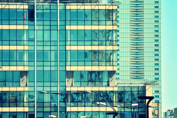 Modern office building on a clear sky background. Retro stylized colorful tonal filter effect