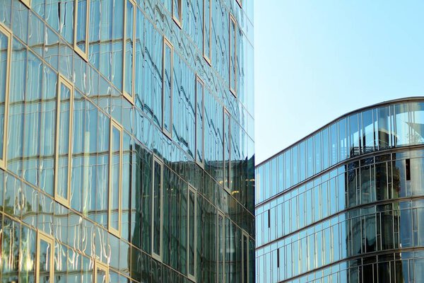 Abstract fragment of contemporary architecture, walls made of glass and concrete.Glass curtain wall of modern office building