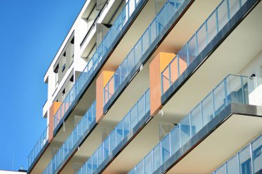 Mavi gökyüzü olan güneşli bir günde modern apartman binaları. Modern bir apartmanın cephesi.