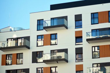 Mavi gökyüzü olan güneşli bir günde modern apartman binaları. Modern bir apartmanın cephesi.