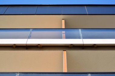 Mavi gökyüzü olan güneşli bir günde modern apartman binaları. Modern bir apartmanın cephesi