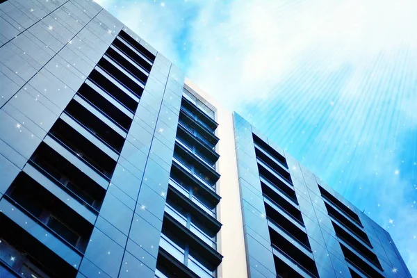 Sky with the stars above a multi-storey residential building.