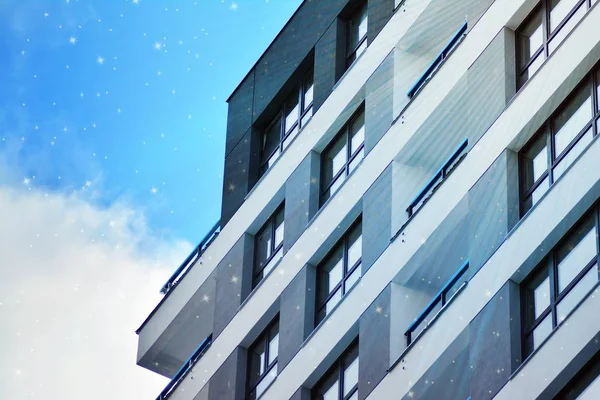 Sky with the stars above a multi-storey residential building.