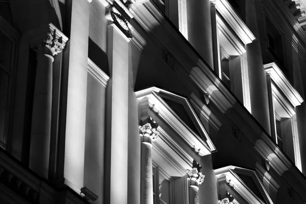 Vintage architecture classical facade illuminated at night. Black and white.
