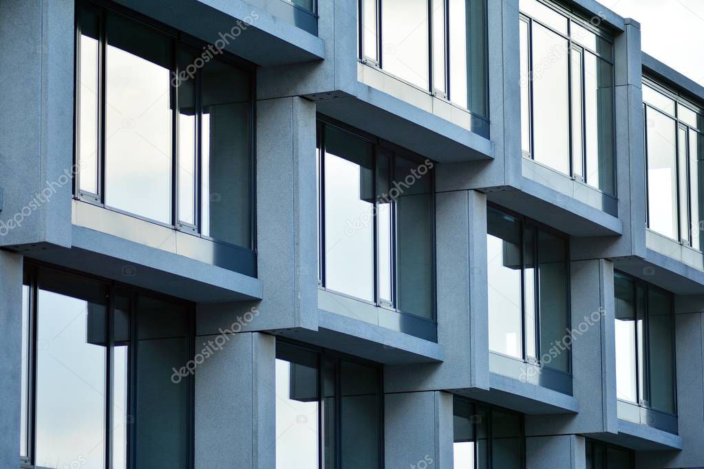Abstract fragment of modern architecture, walls made of glass and concrete.