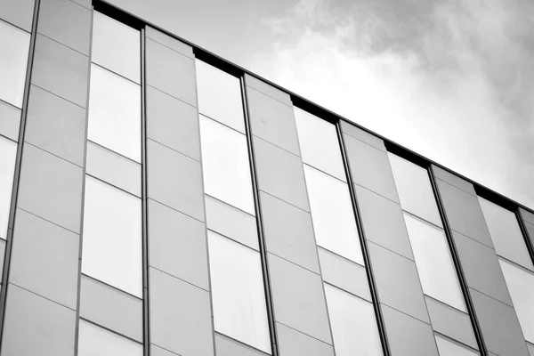 stock image Modern building with reflected sky and cloud in glass window. Black and white.