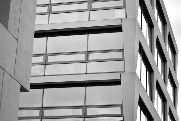 Abstract fragment of modern architecture, walls made of glass and concrete. Black and white.