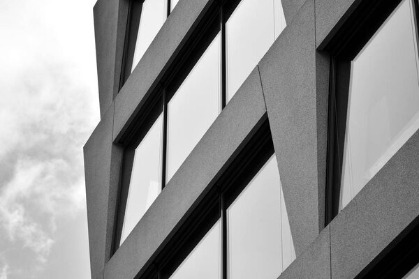 Abstract fragment of modern architecture, walls made of glass and concrete. Black and white.