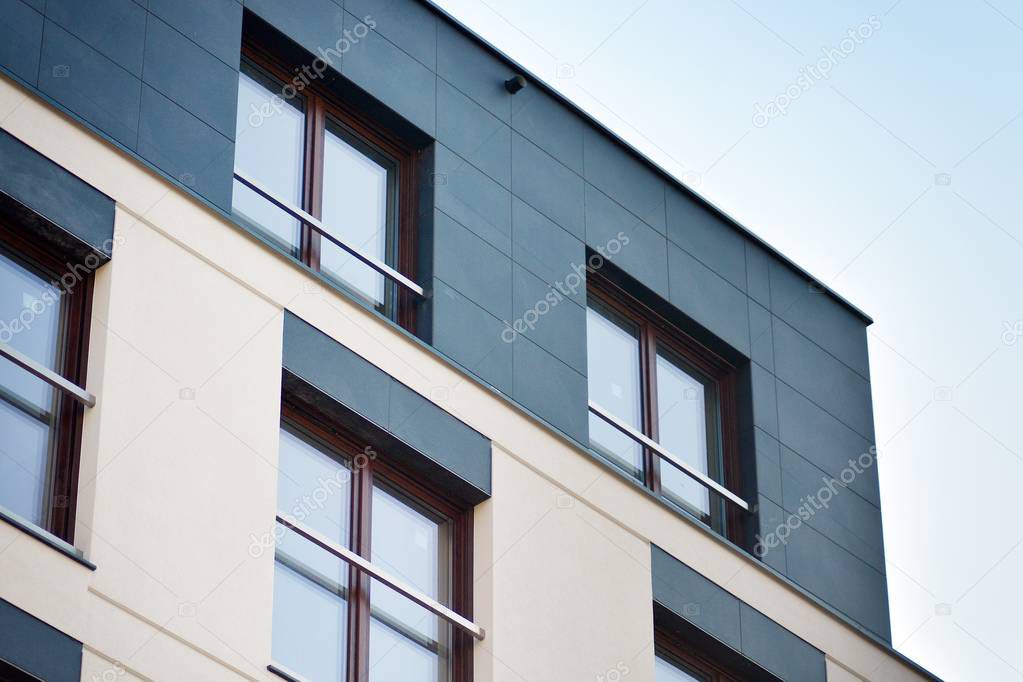 Modern apartment buildings on a sunny day with a blue sky. Facade of a modern apartment building