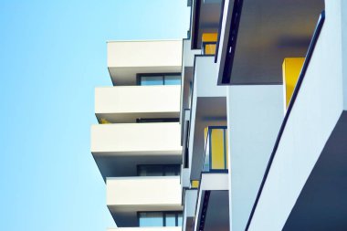 Mavi gökyüzü olan güneşli bir günde modern apartman binaları. Modern bir apartmanın cephesi