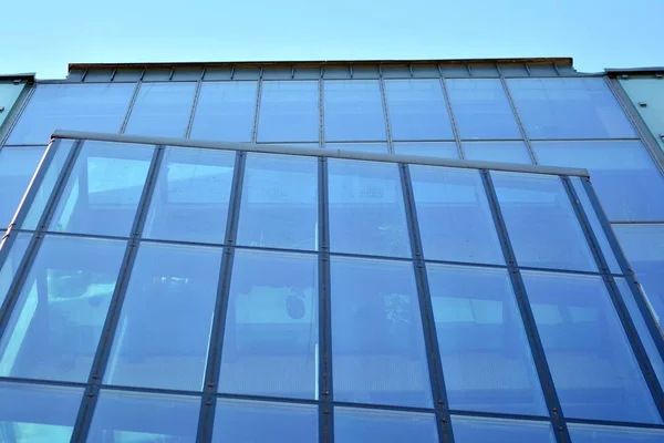 Fragment of abstract architecture - modern urban beauty geometry. Blue glass wall.