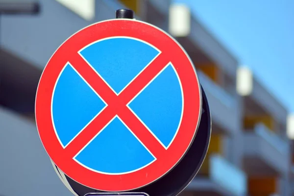 The urban clearway sign with blue skies in the background.