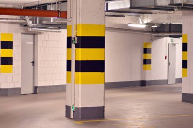 Underground parking garage of a modern apartment building clipart