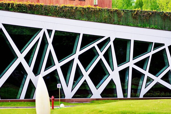 Abstract image of looking up at modern glass and concrete building. Architectural exterior detail of office building.