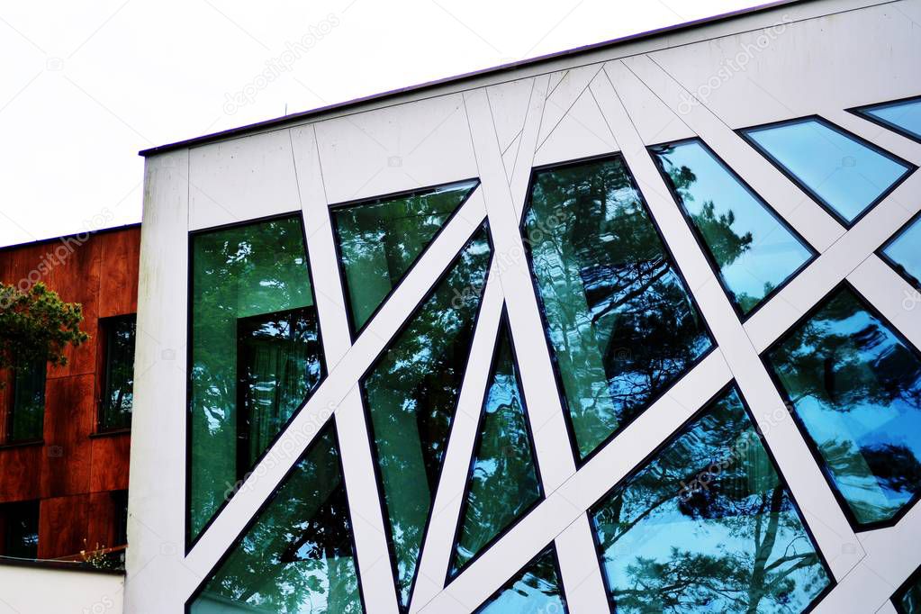 Abstract image of looking up at modern glass and concrete building. Architectural exterior detail of office building.